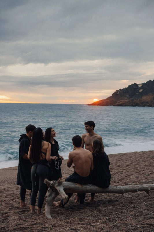 Triathletes in wetsuits on a beach