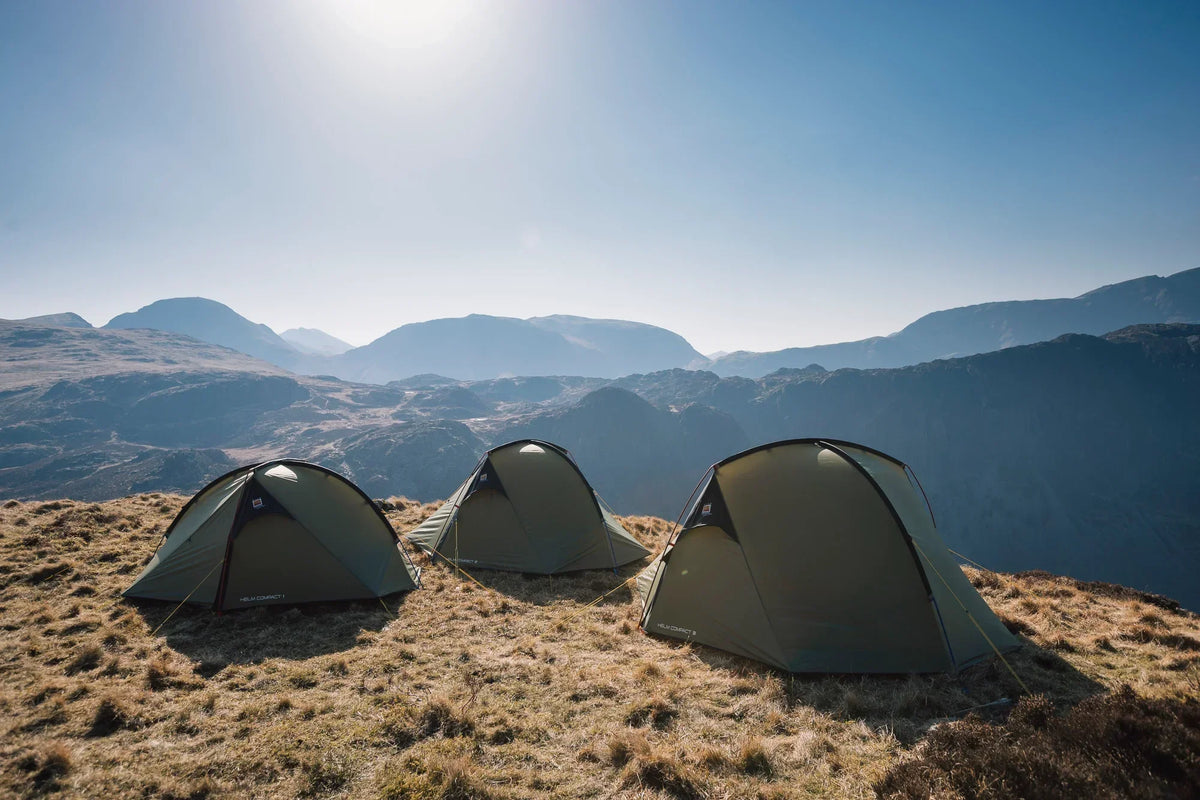 Three tents on a mountain overlooking a pleasant view